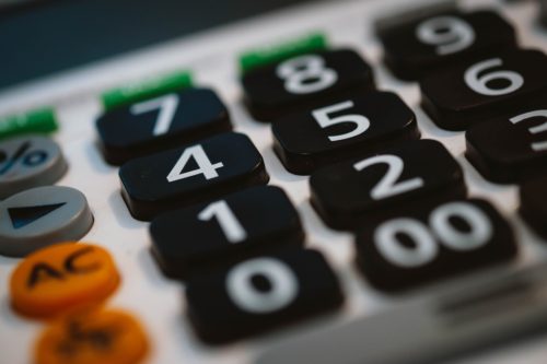 Close-up view of a calculator keypad highlighting the numbers and functional keys, often used in Domestic Identity Fraud cases in California.