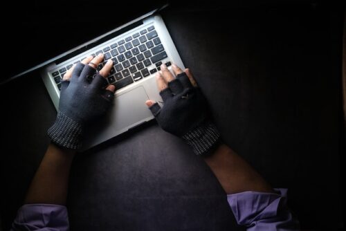 person with gloves on computer