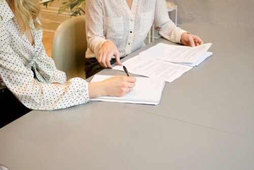 two people looking at papers