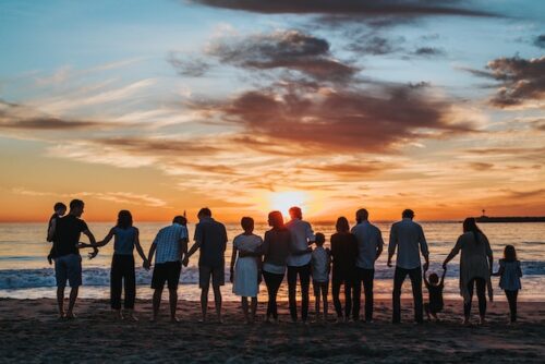 silhouette of family in front of ocean