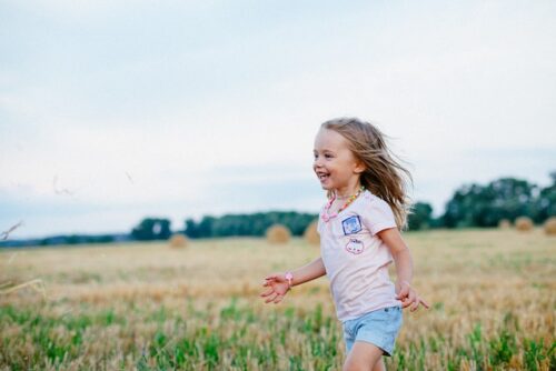 child running through a field