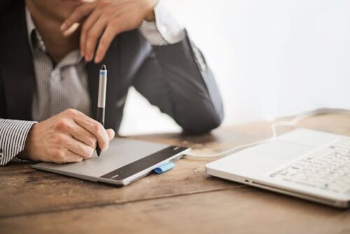 man using stylus and tablet