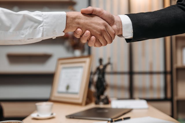 people shaking hands in a law office