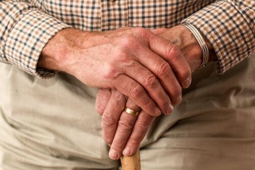 elderly man holding cane