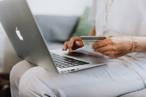 woman inserting credit card info on computer