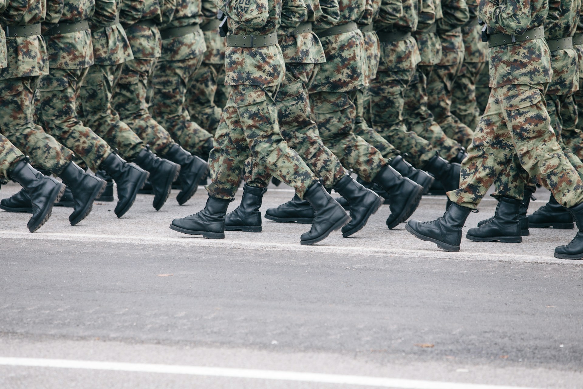 soldiers in fatigues marching