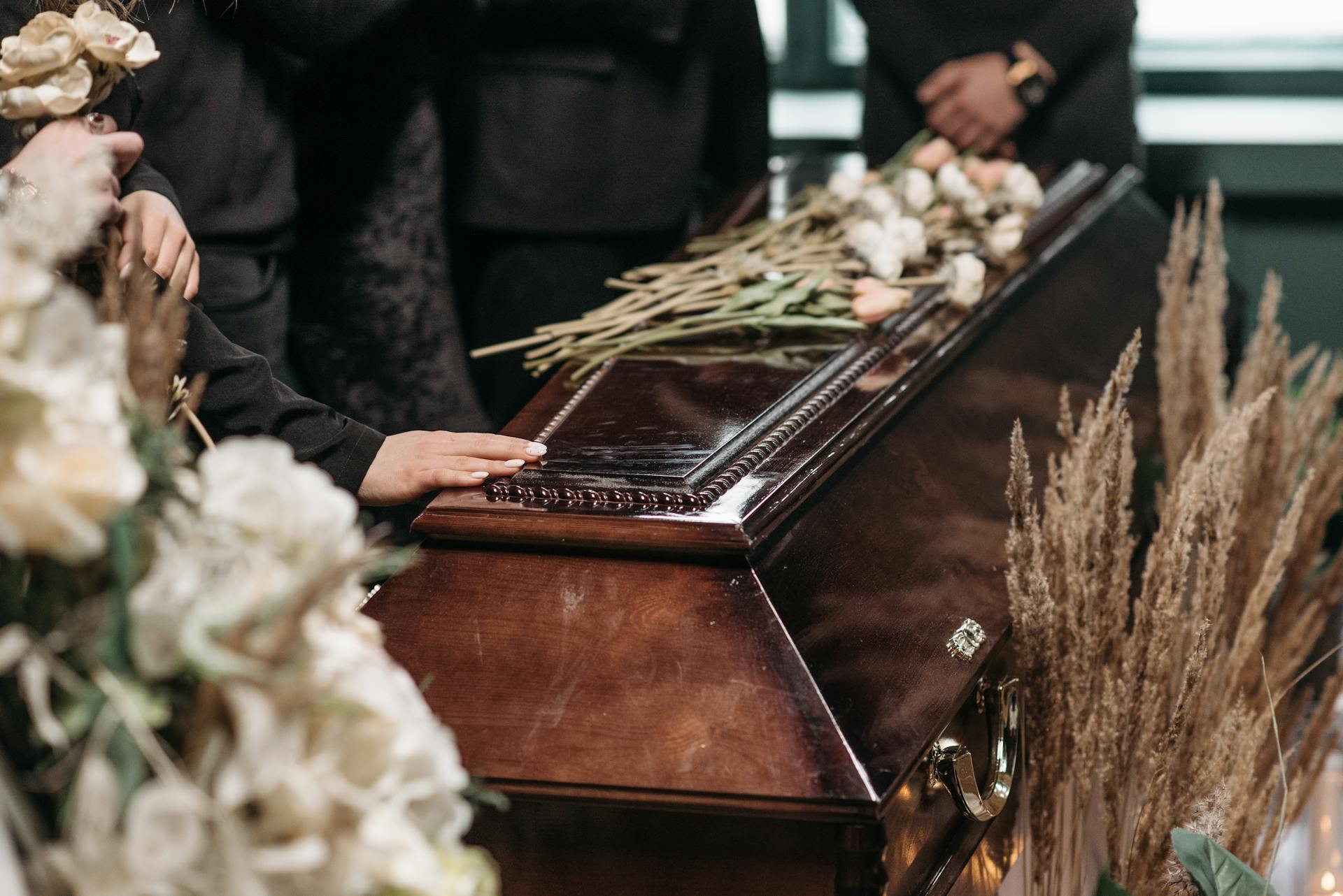 hand on top of casket