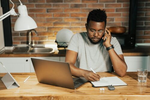 man at desk looking at document